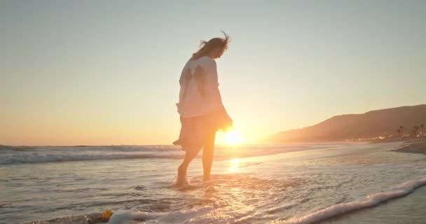Kvinnan njuter av gyllene solnedgång. Film i slow motion med söt kvinna — Stockvideo
