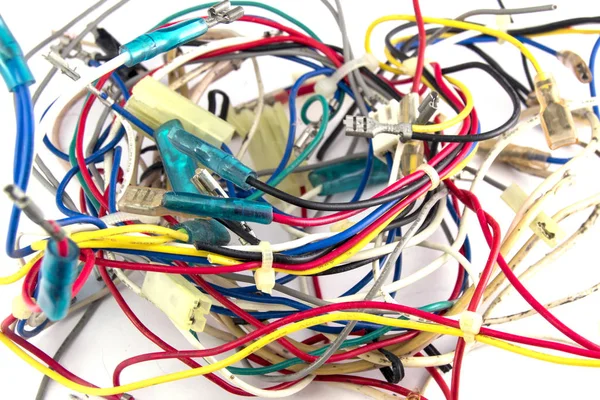 a bunch of intertwined multicolored wires on a white close-up