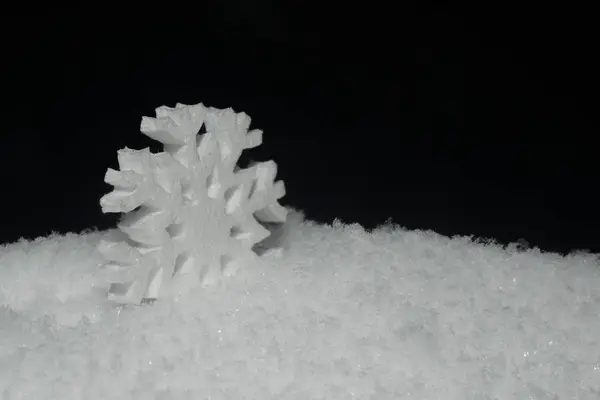 white Styrofoam figurine snowflake on snow