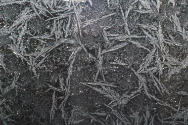 Ice patterns on glass on Christmas Eve. winter background