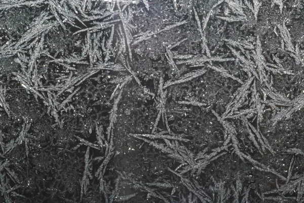 Ice patterns on glass on Christmas Eve. winter background