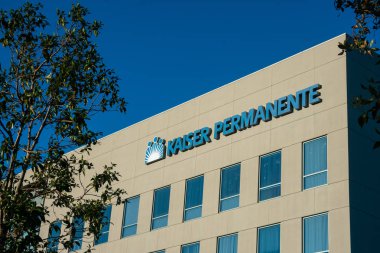 IRVINE, CA\USA - February 9, 2019 - Kaiser Permanente logo on hospital facility building. Kaiser Permanente is a medical care provider based in Oakland, California, United States. clipart