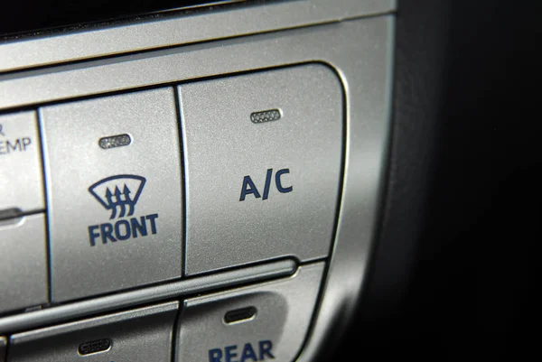 button for activating the air conditioners on the dashboard passenger car