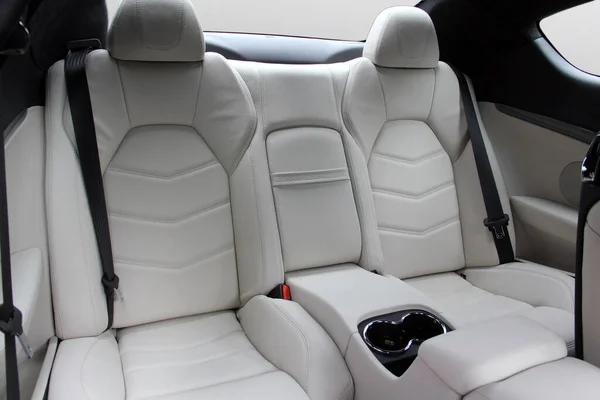 The white rear seat of a luxury sports car