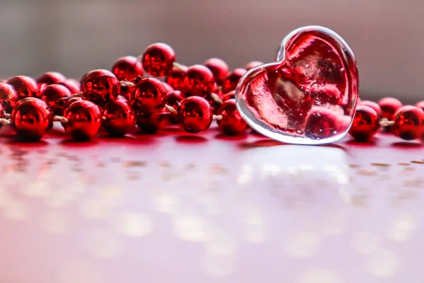 Shining transparent heart and red beads. Perfect Valentine\'s Day greeting card background.