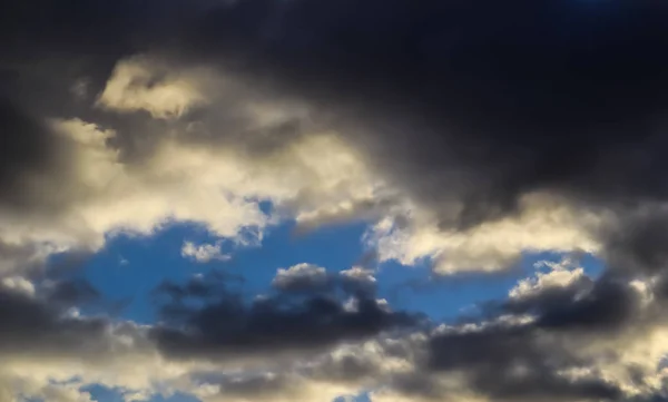 Blue sky and dark clouds with sunlight — Stock Photo, Image