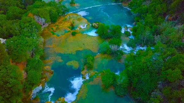 Bird\'s Eye View of Croatia, Europe ; Last sunlight lights up the pure water waterfall on Plitvice National Park. Colorful spring panorama of green forest with blue lake. Great countryside view of Croa