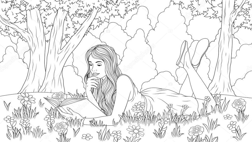 The girl reads a book in the meadow.