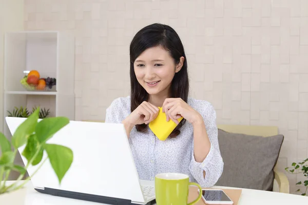 Smiling woman with a wallet