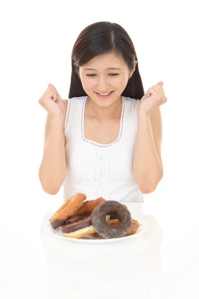 Smiling Young Woman Eating Sweets — Stock Photo, Image