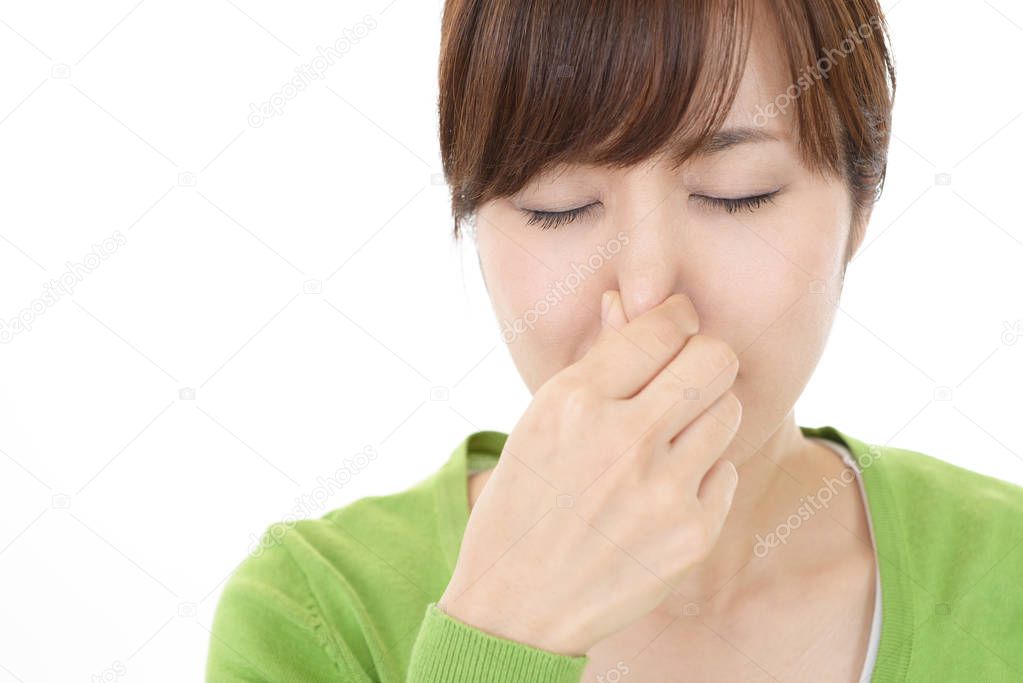 Woman pinches her nose