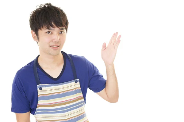 Smiling Asian waiter isolated on white background