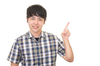 Asyalı adam parmağıyla işaret ediyor.