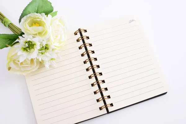 Ring binder book with flowers on the desk