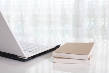 Laptop with books on the desk