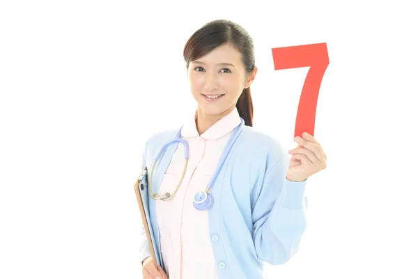 Χαμογελαστή Γυναίκα Νοσοκόμα Ένα Αριθμό — Φωτογραφία Αρχείου