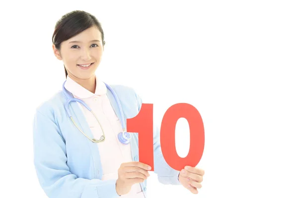 Χαμογελαστή Γυναίκα Νοσοκόμα Ένα Αριθμό — Φωτογραφία Αρχείου