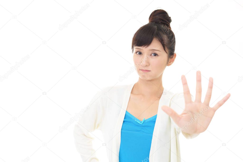 Young Japanese woman making stop sign