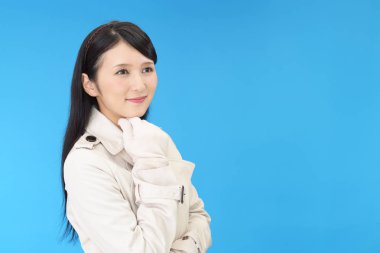 Gülümseyen genç kadın üzerinde mavi arka plan izole