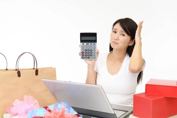 Worried woman with a calculator
