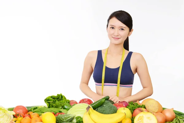 Young healthy woman with fruits and vegetables