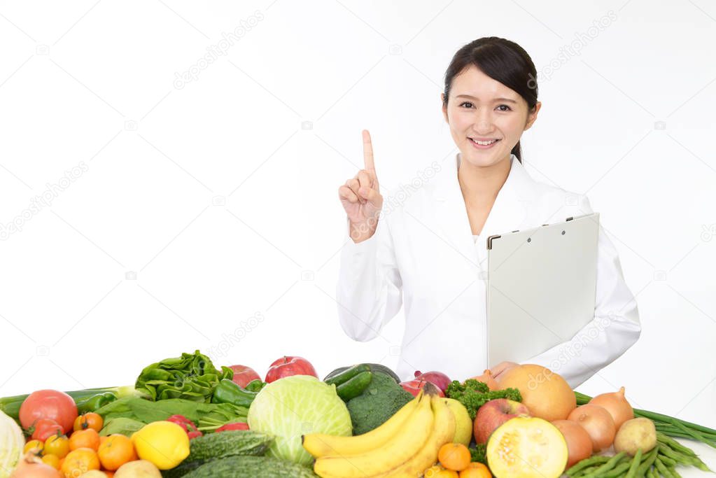 Smiling registered dietitian with fruits and vegetables