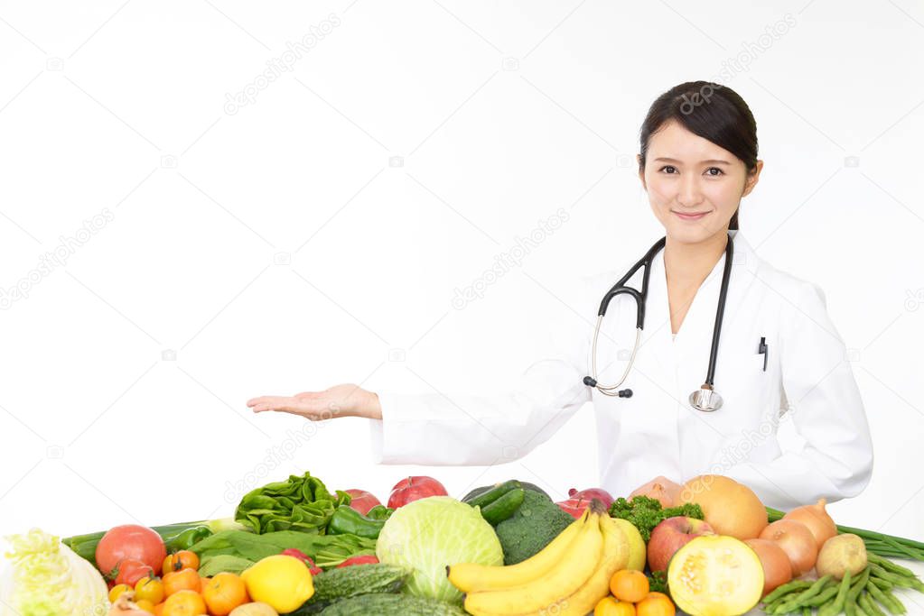 Smiling medical doctor with fruits and vegetables