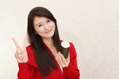 Woman with a sushi roll clipart