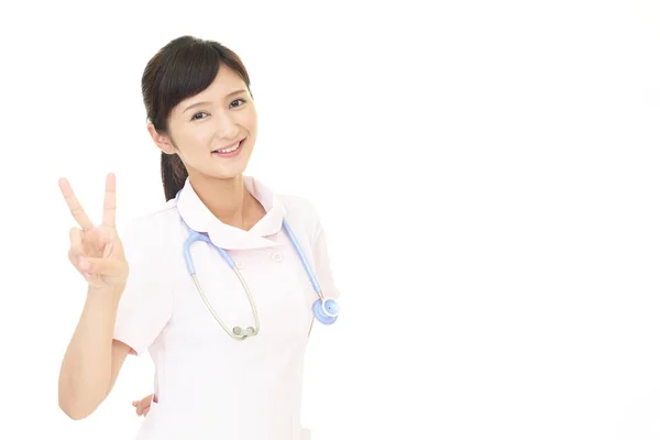白い背景に分離番号 つジェスチャーを示す若い医療看護師の肖像 — ストック写真