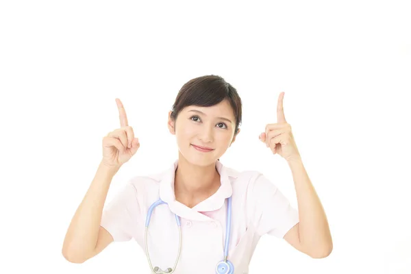 Female Nurse Pointing Upward — Stock Photo, Image