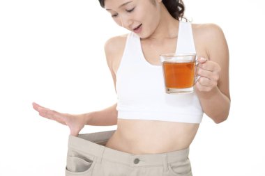 Ayakta ve kilo kaybetme sonra çok büyük pantolon giyen kadın