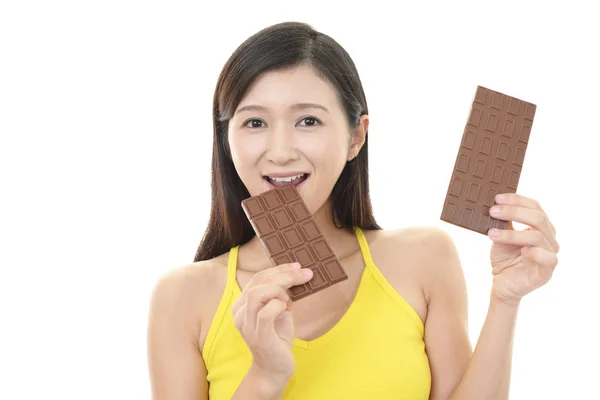 Happy Young Woman Eating Chocolate — Stock Photo, Image