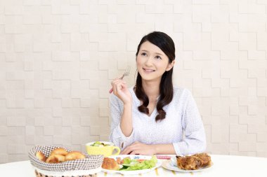 Genç bayan kahvaltı yapıyor.