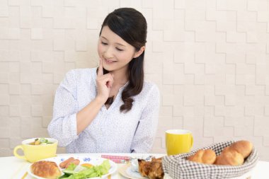 Genç bayan kahvaltı yapıyor.