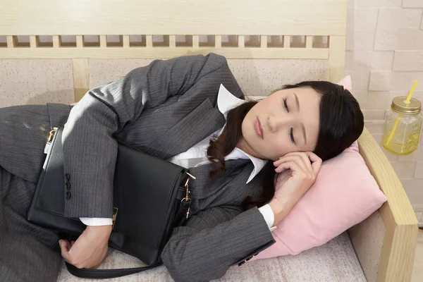 Tired business woman sleeping on a couch