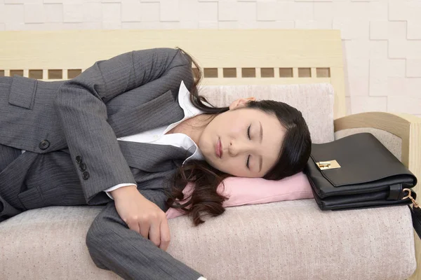Tired business woman sleeping on a couch
