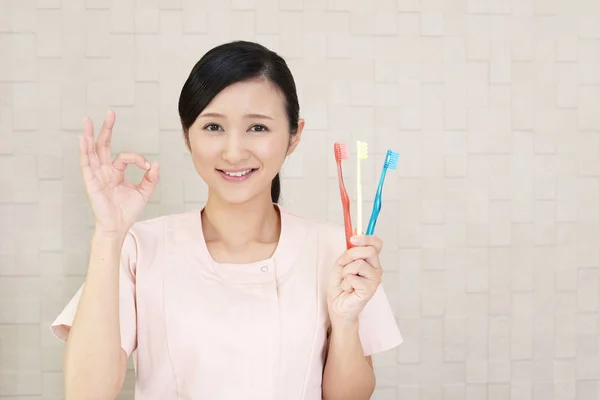 Dental hygienist with ok hand sign