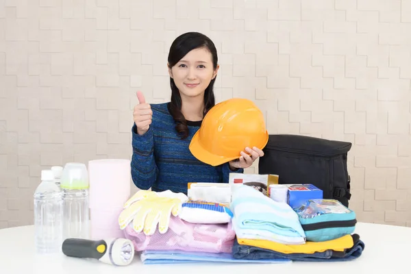 Woman with emergency preparedness kit