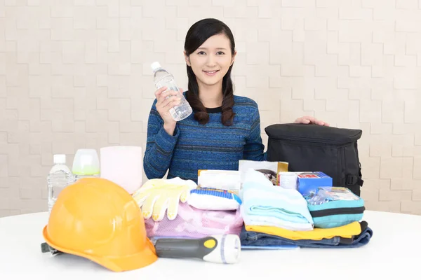 Woman with emergency preparedness kit