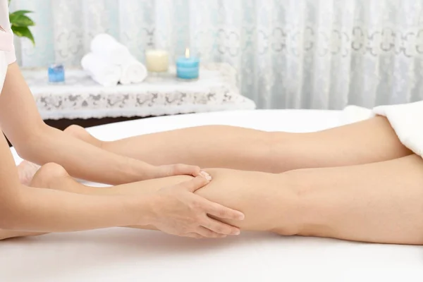 Close-up of leg receiving massage in spa