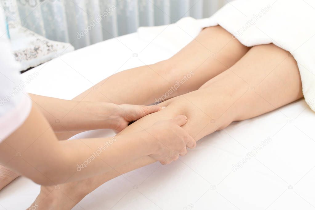 Close-up of leg receiving massage in spa