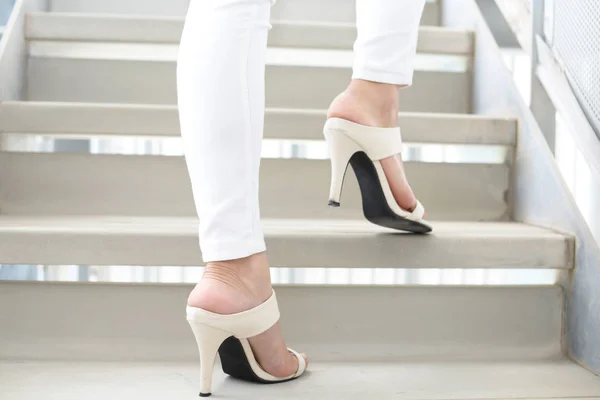 Woman legs in fashionable high heel sandals