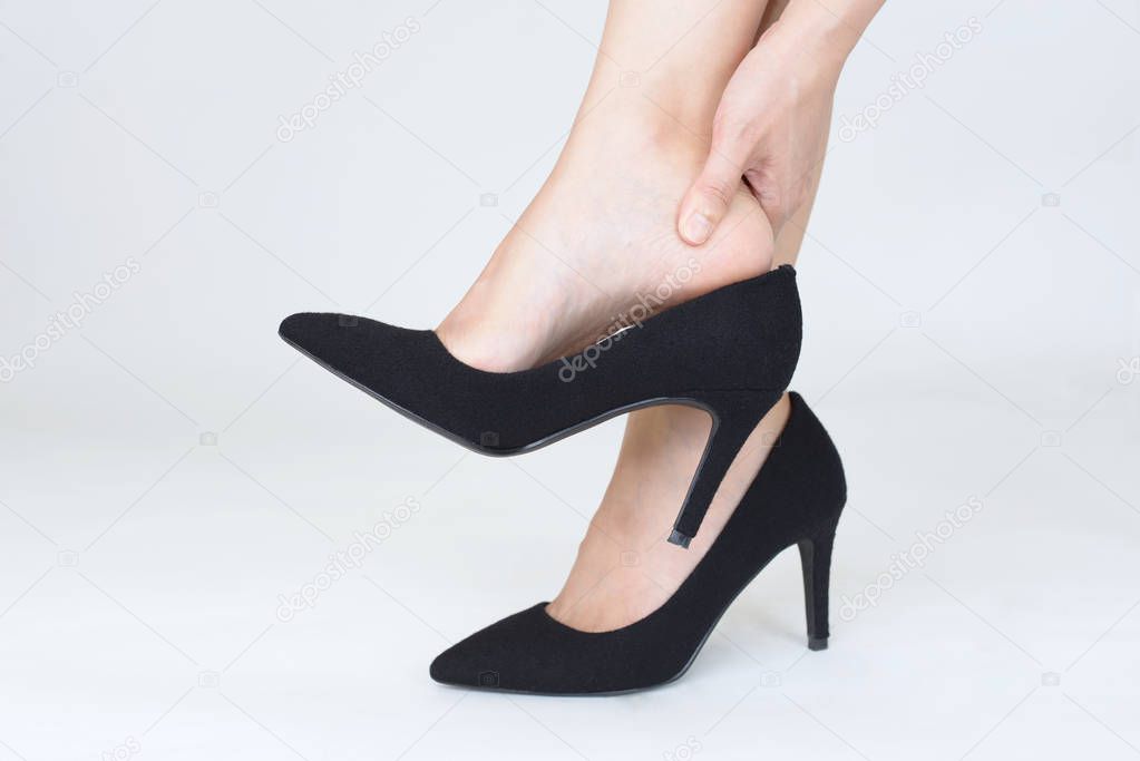 Woman holding painful sprained ankle