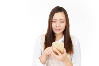 Bir akıllı telefon kullanan gülümseyen kadın