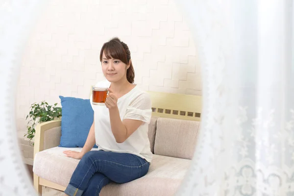 Woman having tea at home