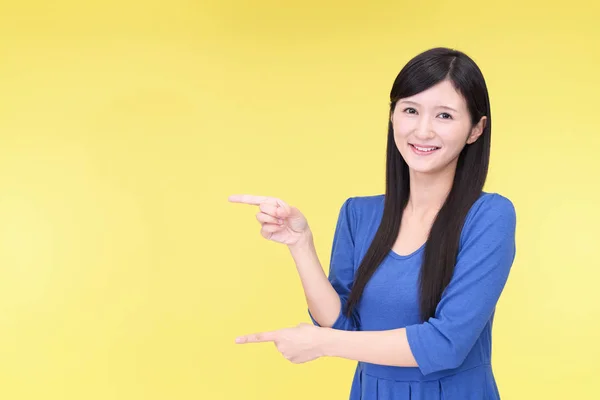 Asian young woman pointing with her fingers