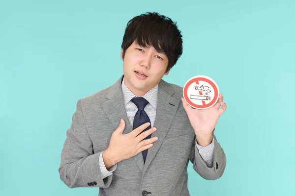 Man holds non smoking sign