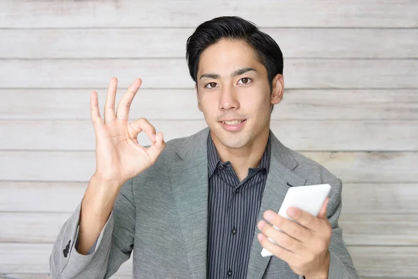 Businessman Holding Smart Phone — Stock Photo, Image