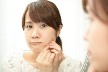 Cilt sorunu olan endişeli bir kadın.