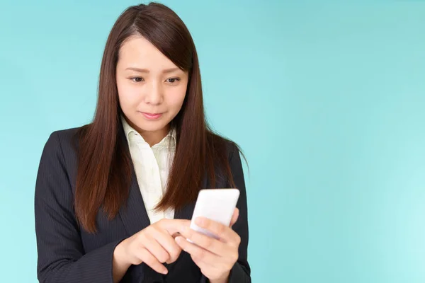 Business woman looking at smart phone